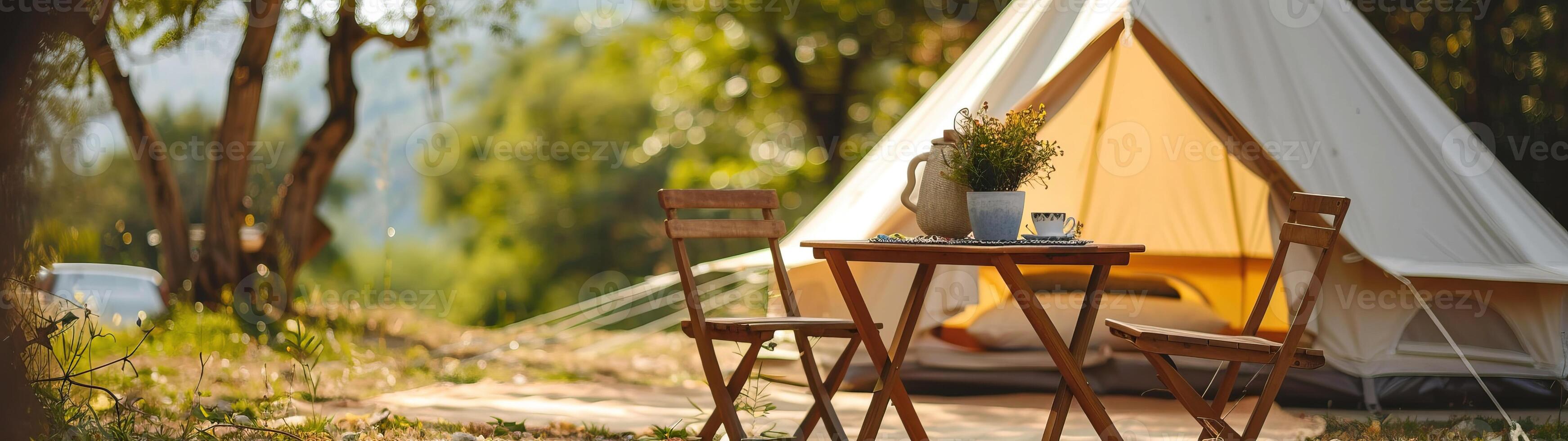 Cozy glamping setup with a canvas tent and wooden furniture in a peaceful forest setting, perfect for a relaxing nature getaway. photo