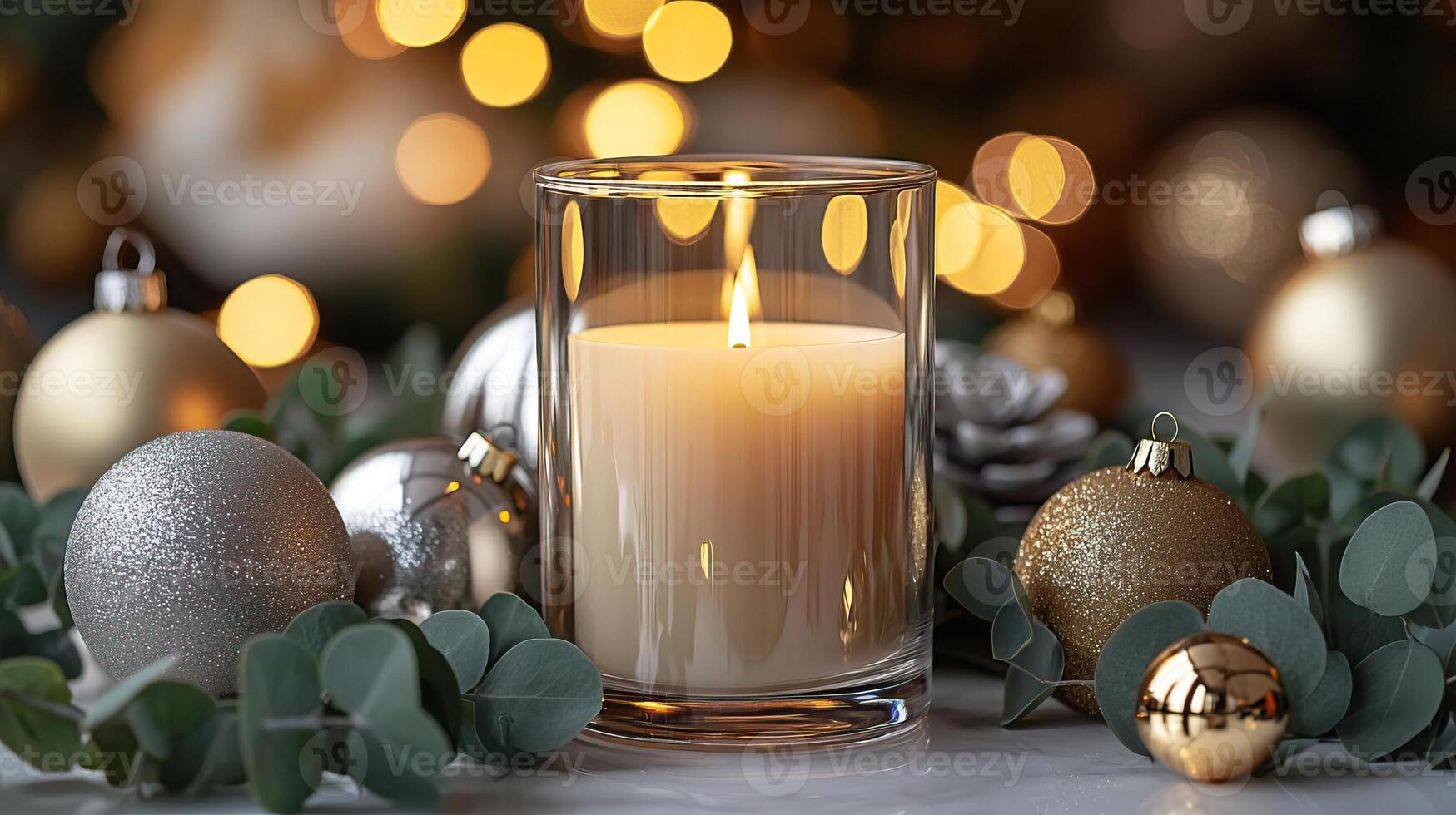 Blank clear straight candle glass surrounded by sleek gold and silver baubles, eucalyptus sprigs, and warm lighting, modern minimalist Christmas mockup, chic and stylish photo