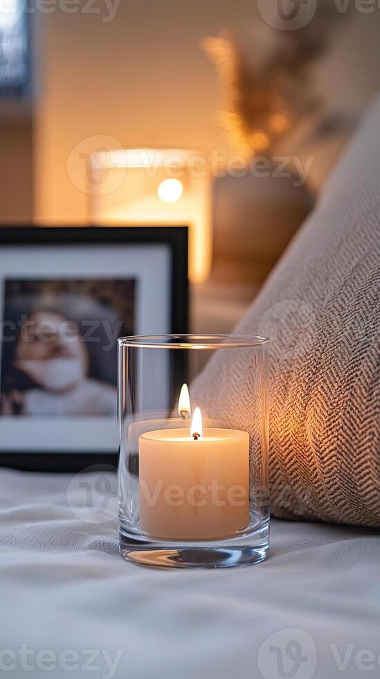 Blank clear straight candle glass amidst a setting with a plush pillow, a scented diffuser, and delicate string lights, modern warm bedroom mockup, serene and stylish photo