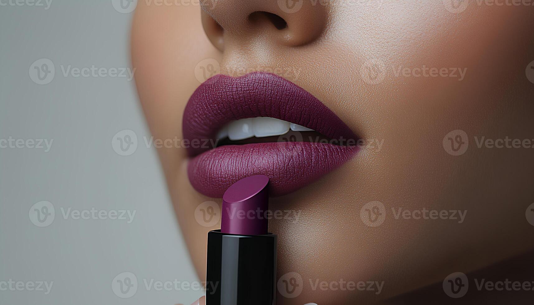 Woman holding a tube of purpl lipstick near her lips for a beauty campaign concept. woman holding and applying purple lipstick on her lips for beauty campaign shot. tube of burgundy lipstick photo
