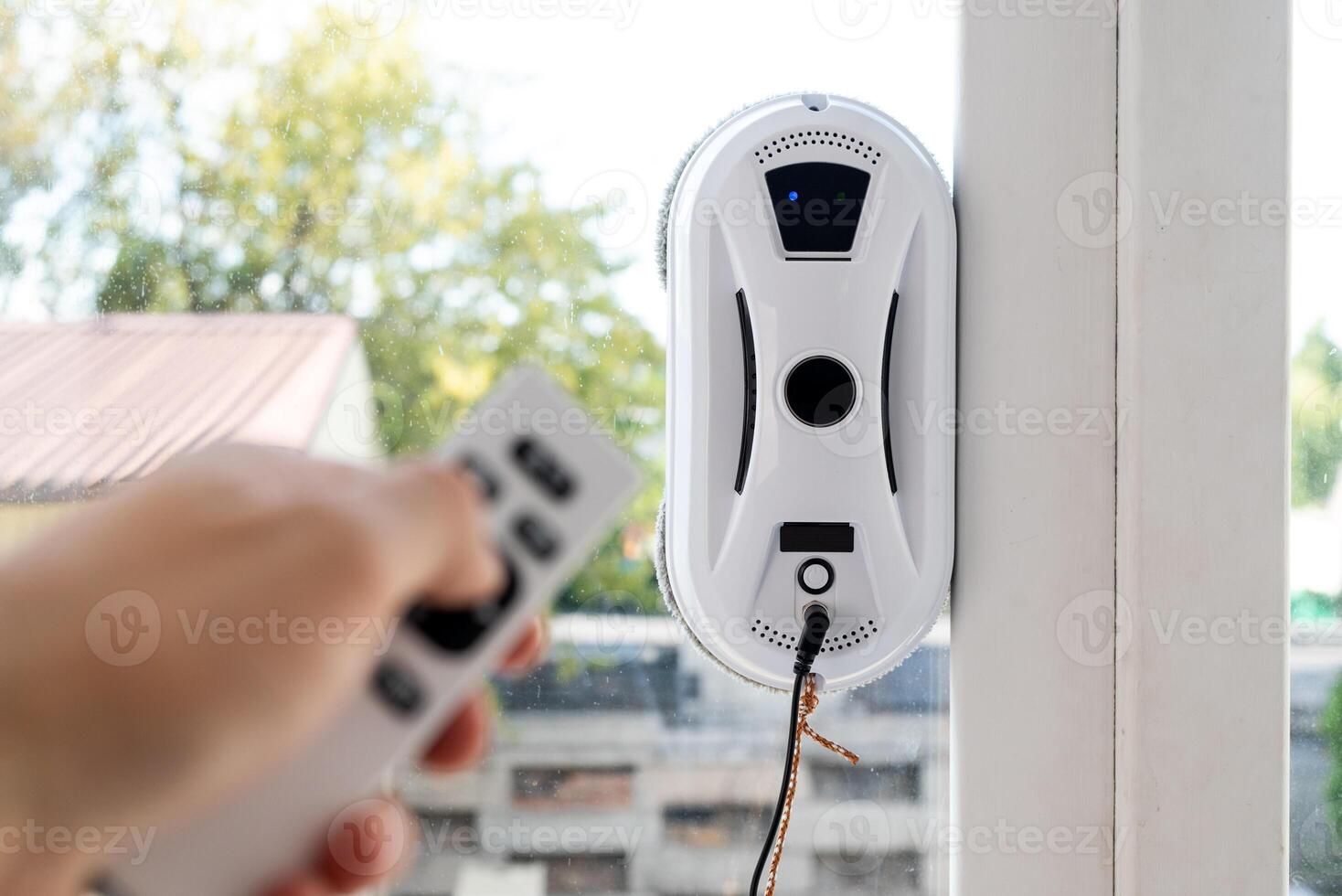 Remote control of a robotic window washer that washes glass from dirt and stains. photo
