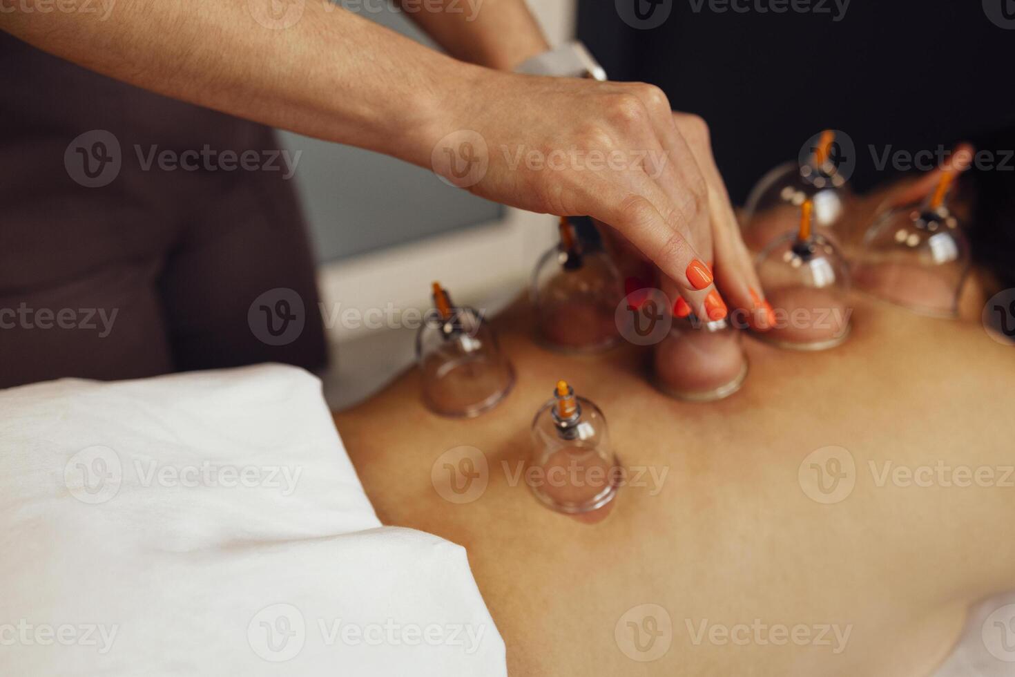 Faceless masseur rubbing back of customer photo