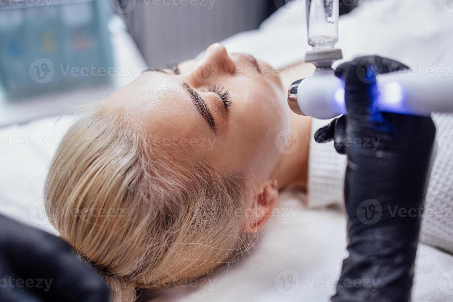 Rejuvenating facial gas liquid treatment. Hydro air skin cleansing operation photo
