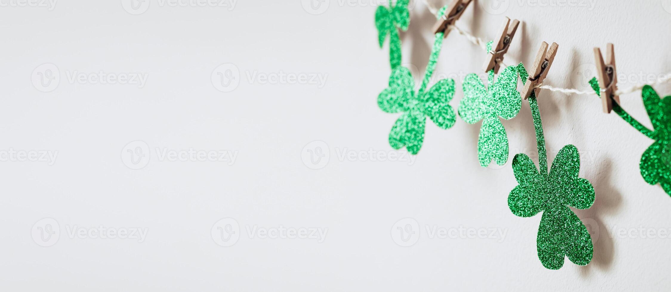 Happy St. Patricks day background with Green glitter shamrocks decoration, banner format photo