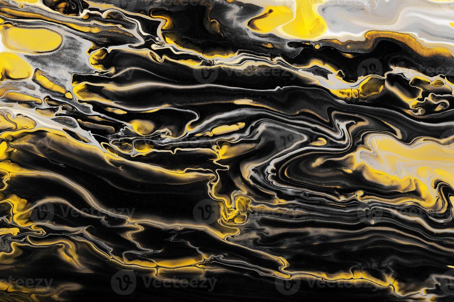 Yellow inclusions in black waves and curls. Marble effect background or texture. Fluid Art photo