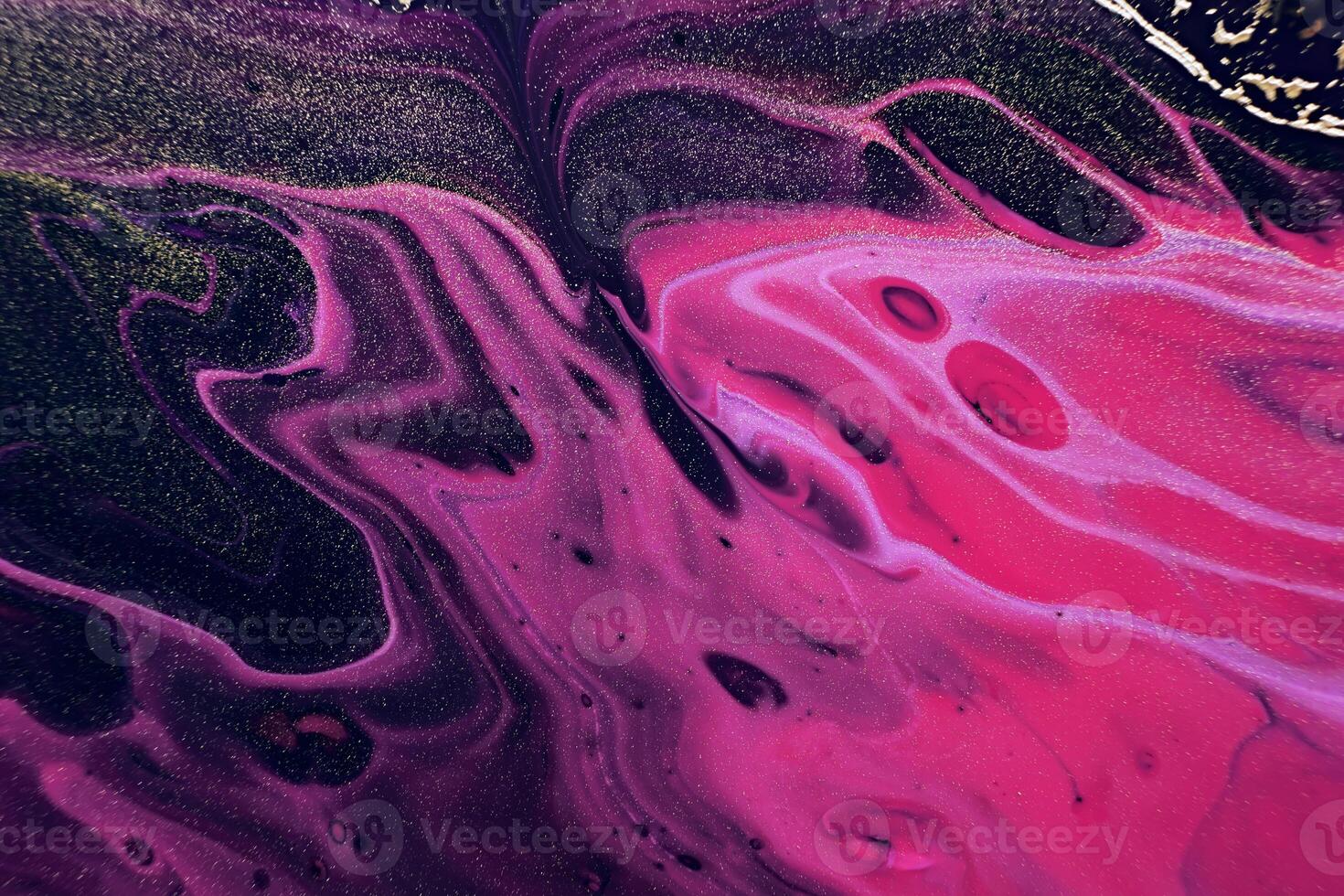 Fluid Art. Golden metallic particles and pink waves. Marble effect background or texture photo