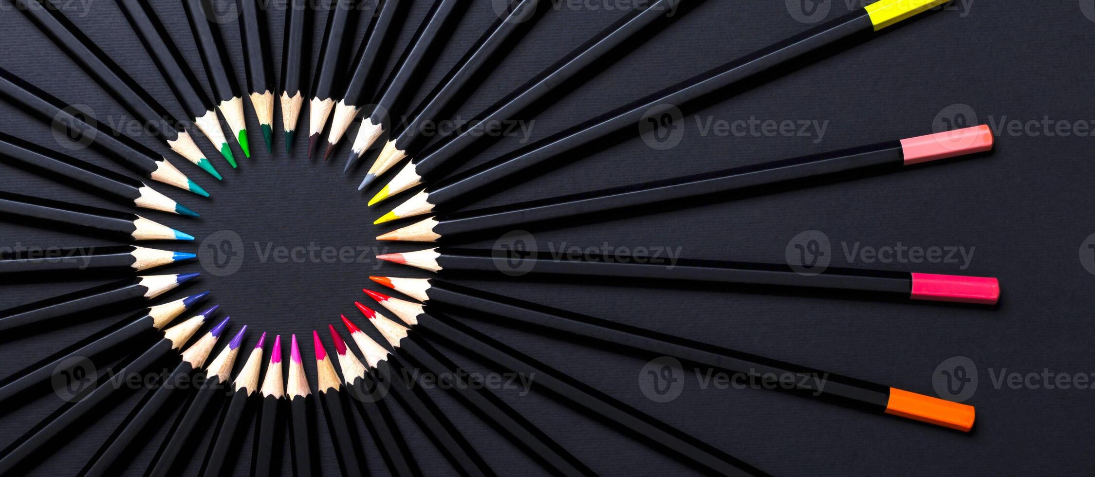 Creative minimal banner. Colored pencil set arranged in circle on black background photo