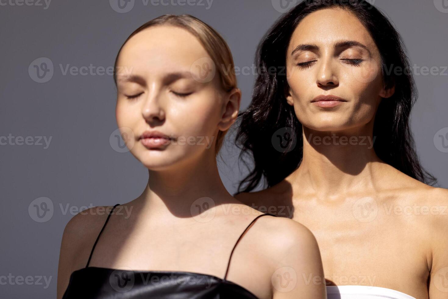 two women with their eyes closed in a pose photo