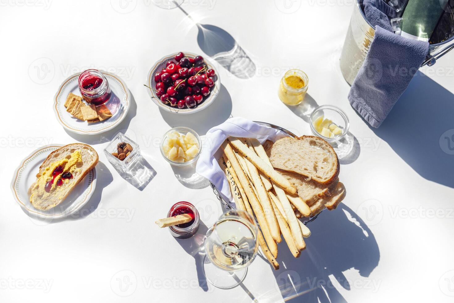 Elegant glass of delicious sparkling wine on background of table photo