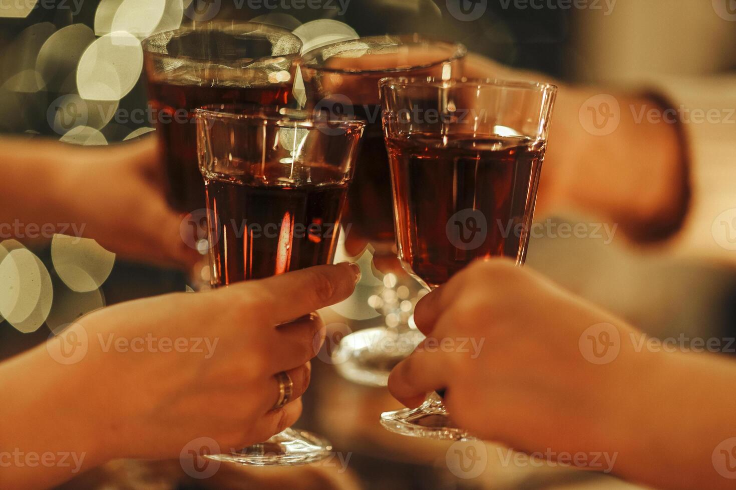 Family friends have fun together in winter eating food on a wooden table photo