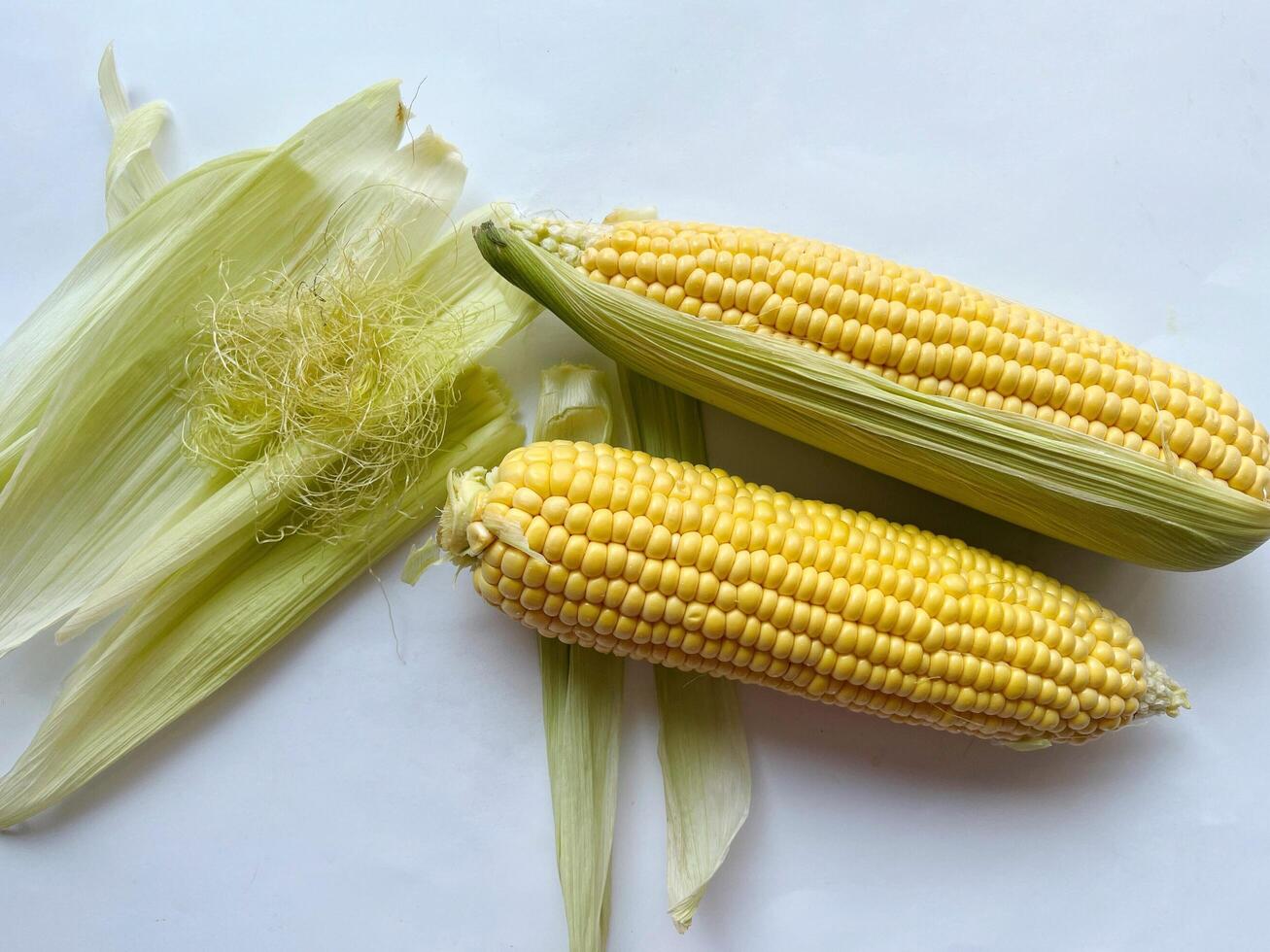 Close up corn hair in bowl and fresh corn. Corn hair has the benefit of lowering blood pressure, high cholesterol and arthritis photo