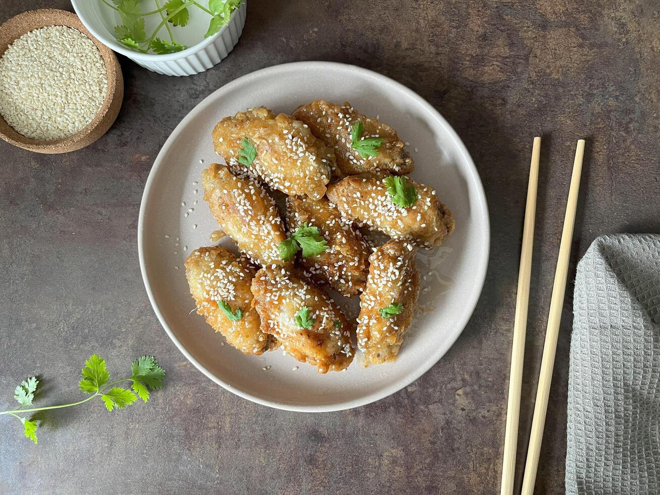 Homemade sticky Asian Honey Garlic Chicken Wings sprinkled with sesame seeds on plate. Perfect for article, recipe book and creative production. photo
