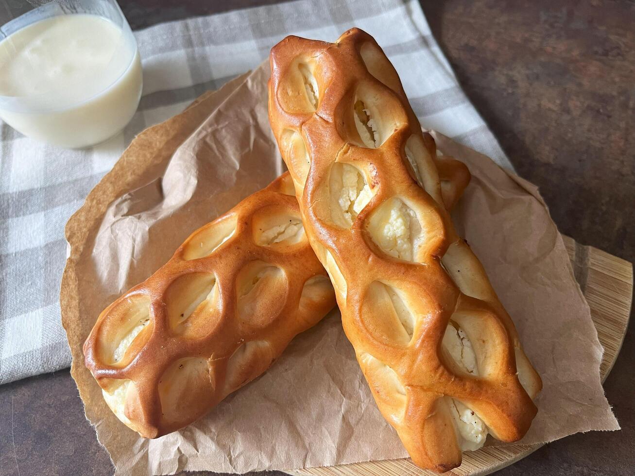 Buns with cottage cheese filling, made from flour, water, sugar, vegetable fats, sugar, starch, salt, flavorings, yeast, vanilla, the curd filling. Perfect for recipe books, articles, creative project photo