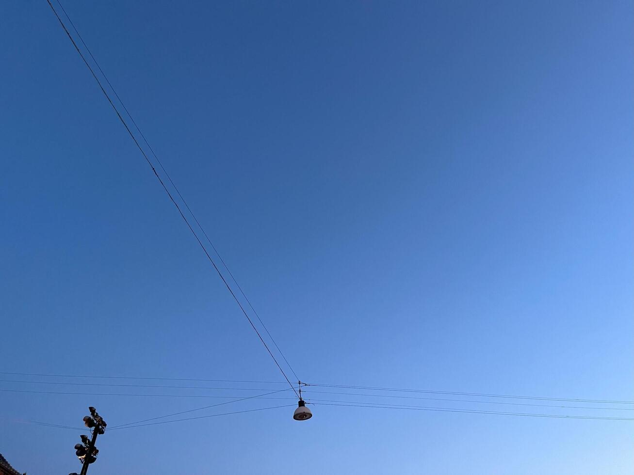 Clear evening sky with wires and lights photo