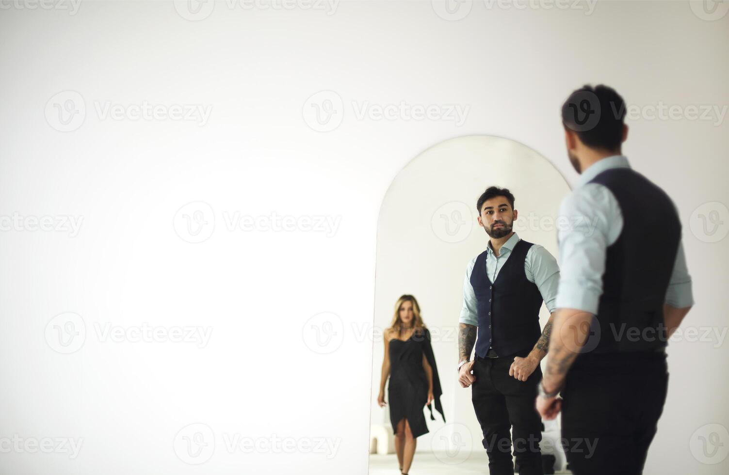 a man and woman standing in front of a mirror photo