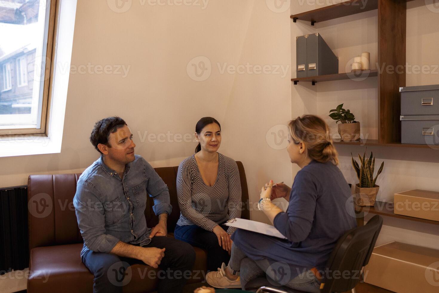 Couple visiting a psychologist and having a psychological session while dealing with problems in relationships together photo