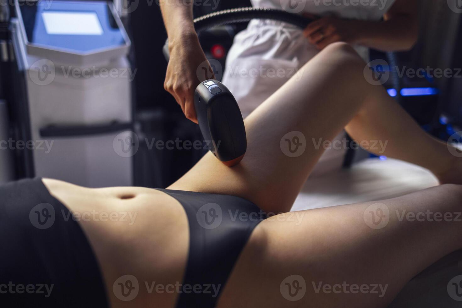 Young woman receiving photo epilation while visiting beauty center on salon