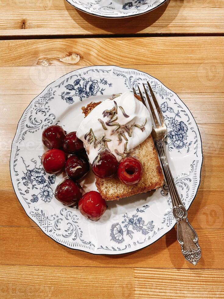 Pattern of plate with a sweet dessert on it. Appetizing slices of pie with cherries photo