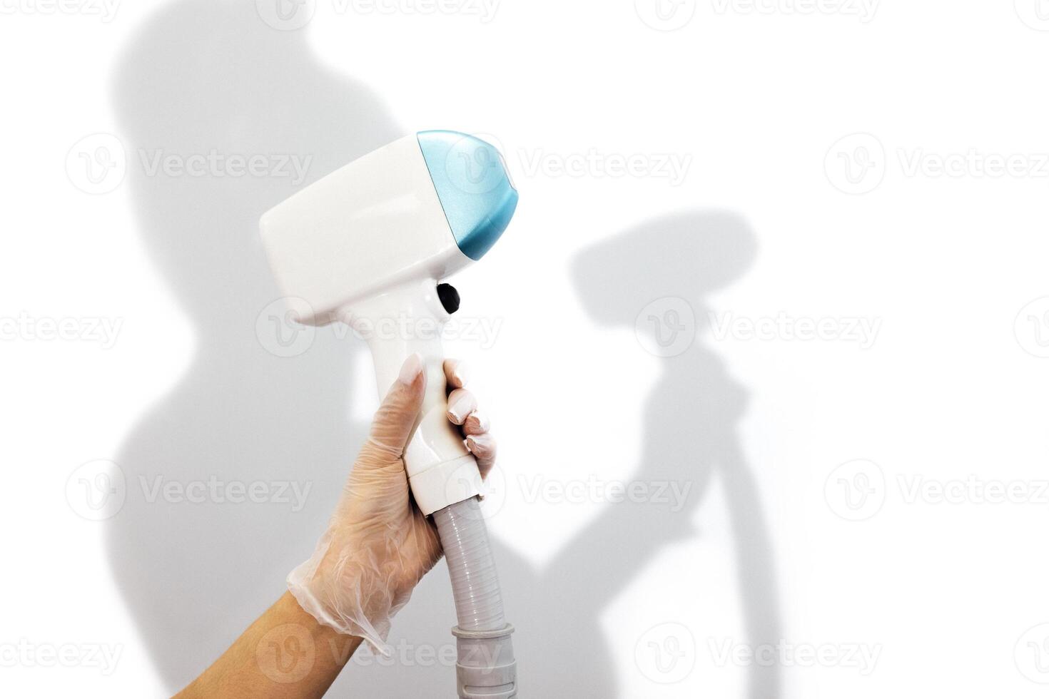 Young woman beautician in medical uniform adjusting machine for photorejuvenation or laser photo