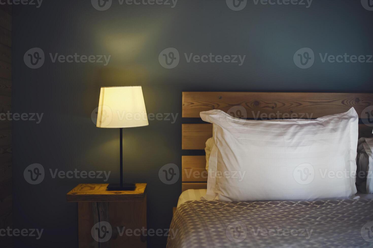 Night scene in cozy room, nightstand with lamp photo