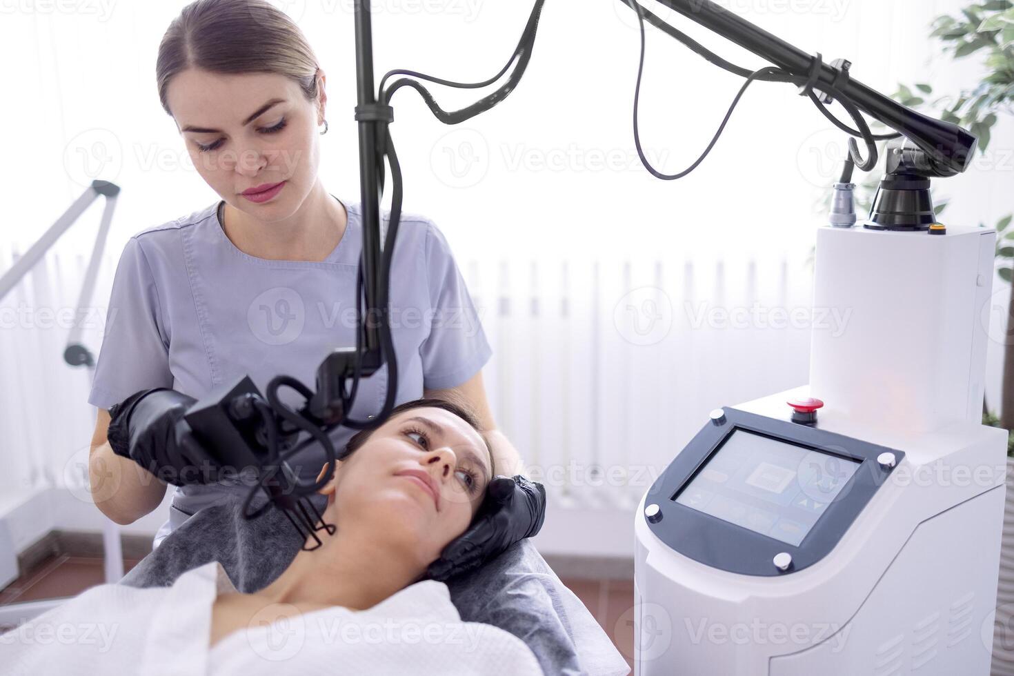 young woman undergoing laser resurfacing and peeling procedure photo