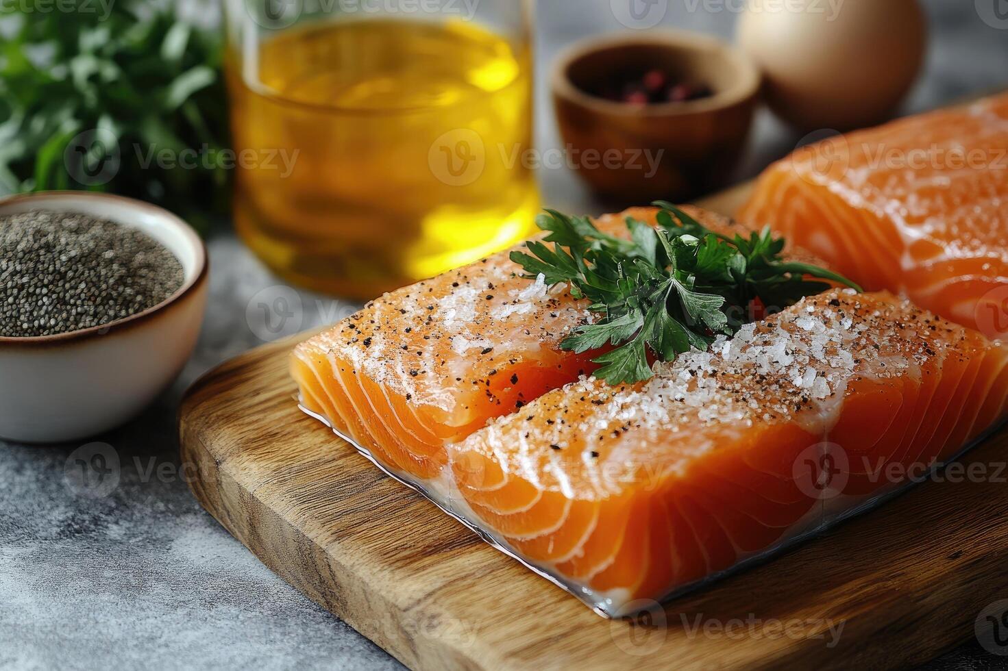 Fresh salmon fillet seasoned with salt and peppercorns on a cutting board photo