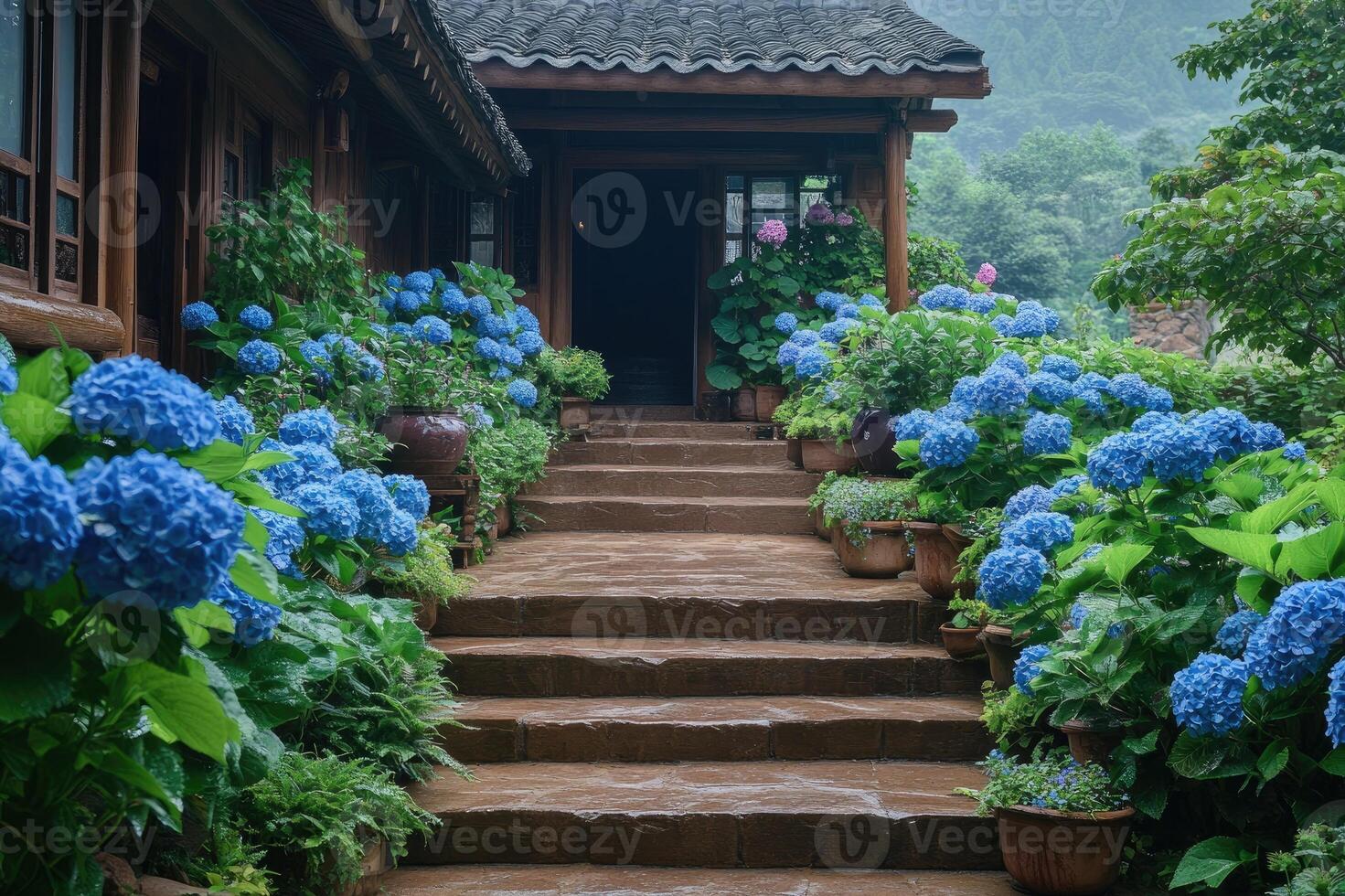 A charming outdoor stone staircase leads to a house, adorned with blooming blue and pink hydrangeas, creating a serene and picturesque garden pathway. photo
