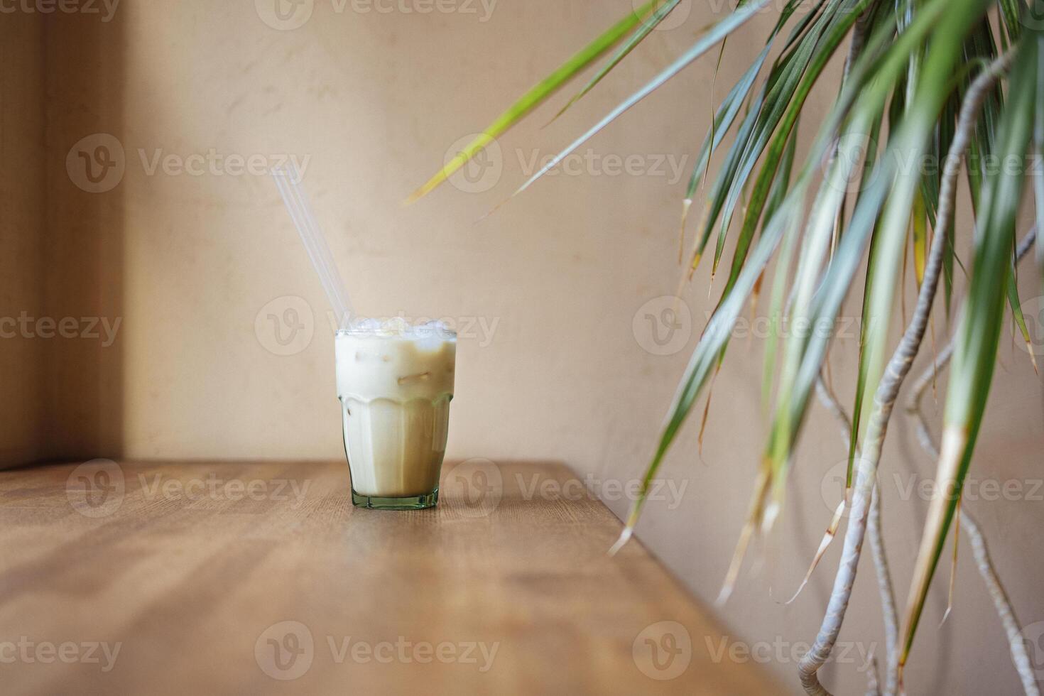 Iced coffee latte in a tall glass with caramel and chocolate syrup and whipped cream photo