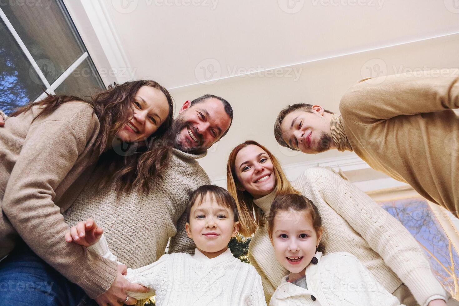 Happy large caucasian family with many children making selfie photo at home, looking at camera.