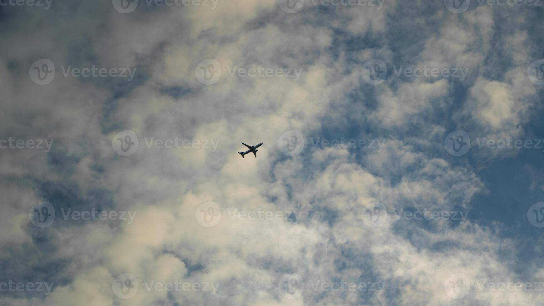 A passenger plane takes off into the sky. A plane among the clouds. Minimalism photo