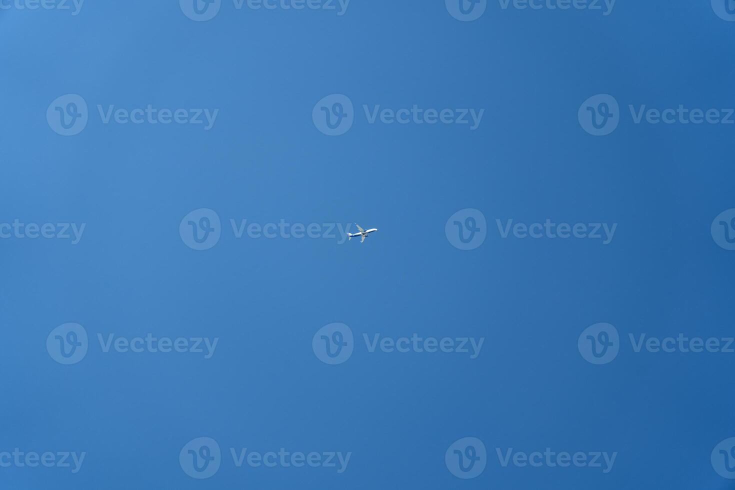A passenger plane is flying far in the sky. Minimalism photo