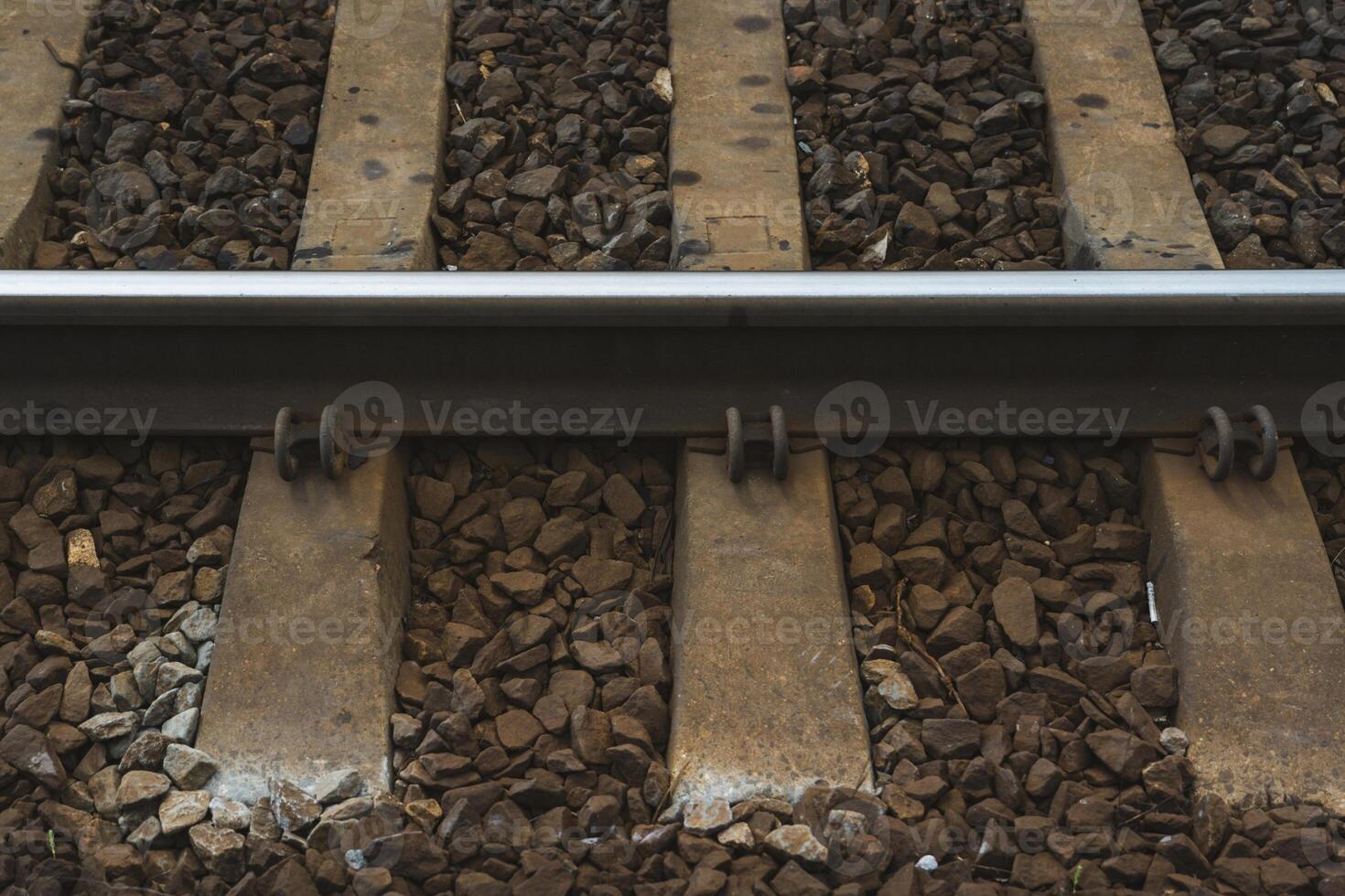 Railway rail, sleepers across, at one of the stations. Railway tracks photo
