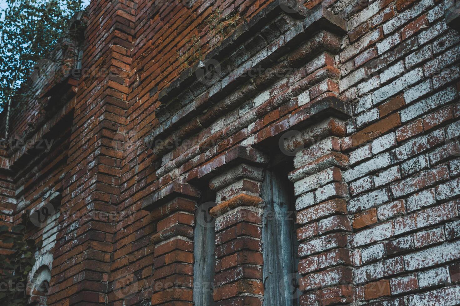 Vertical windows in an old brick building photo