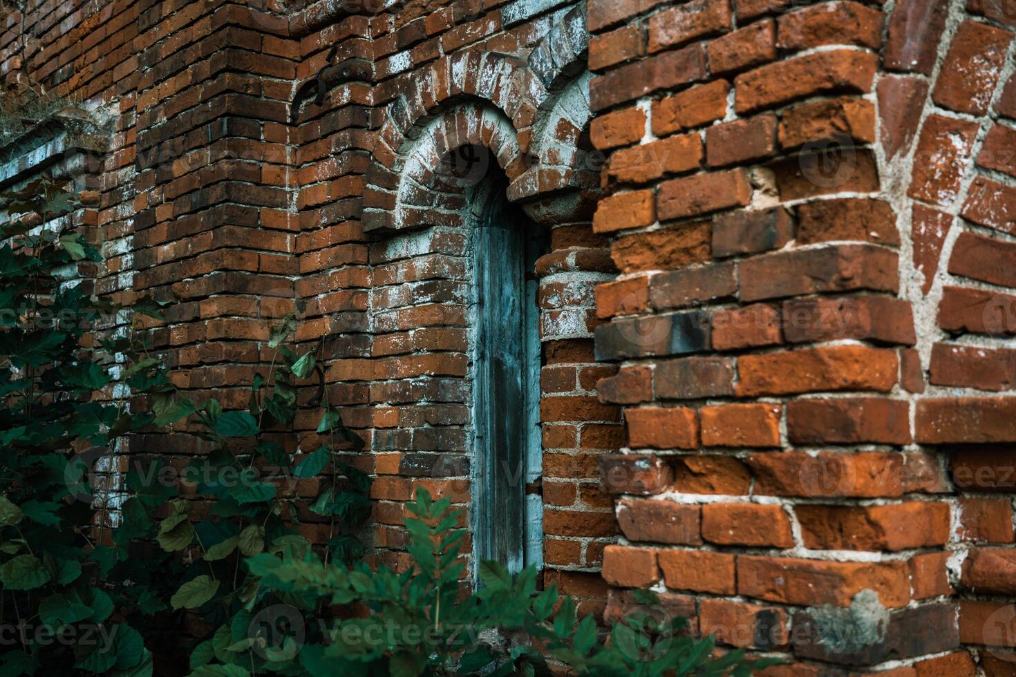 A vertical window in a brick stable. 19th century buildings. photo