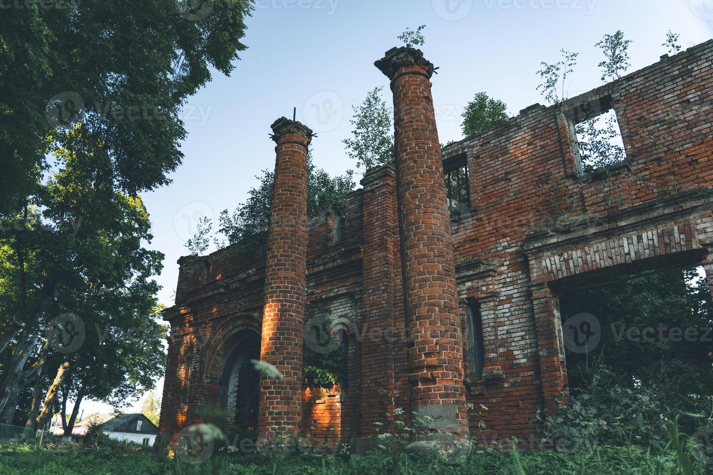 Two old, dilapidated, brick columns, at the entrance to the stable photo