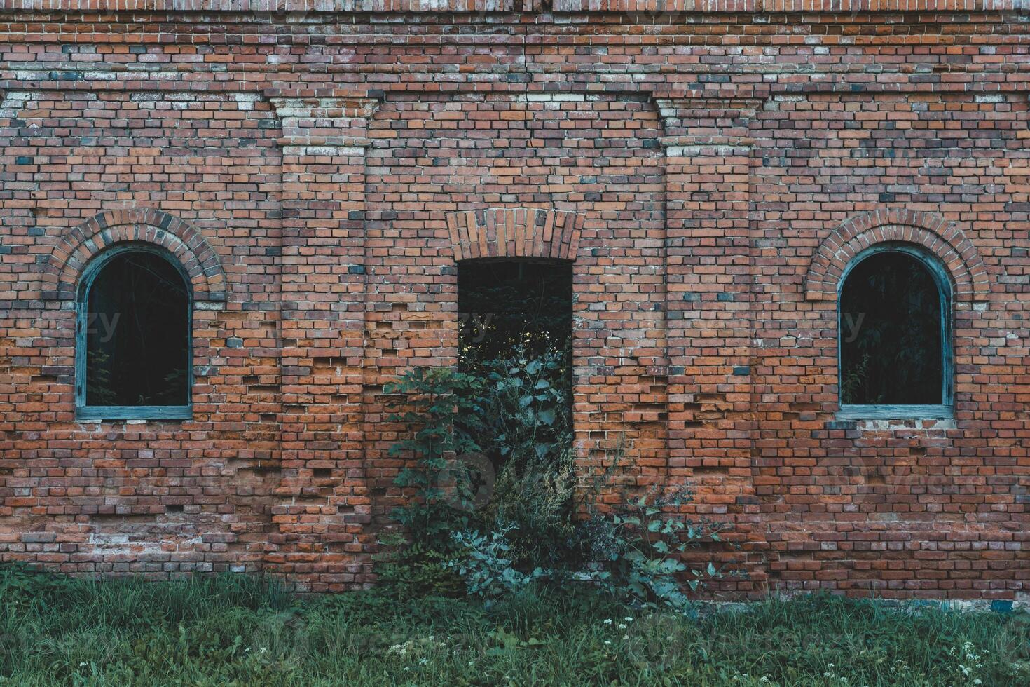 The windows of a ruined brick stable. 19th century buildings photo