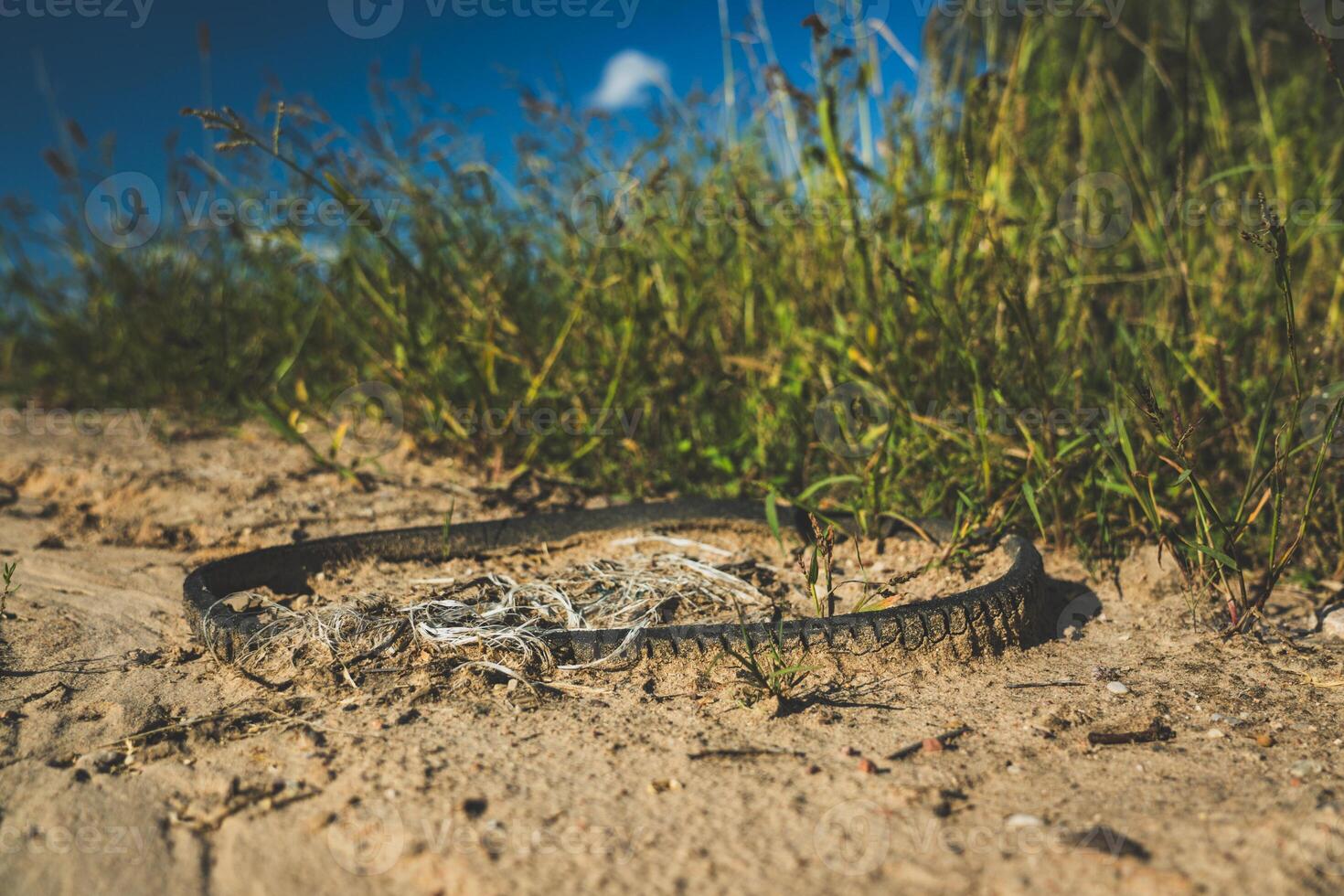 Garbage is lying on the road. The rubber, automobile belt lies on the road photo