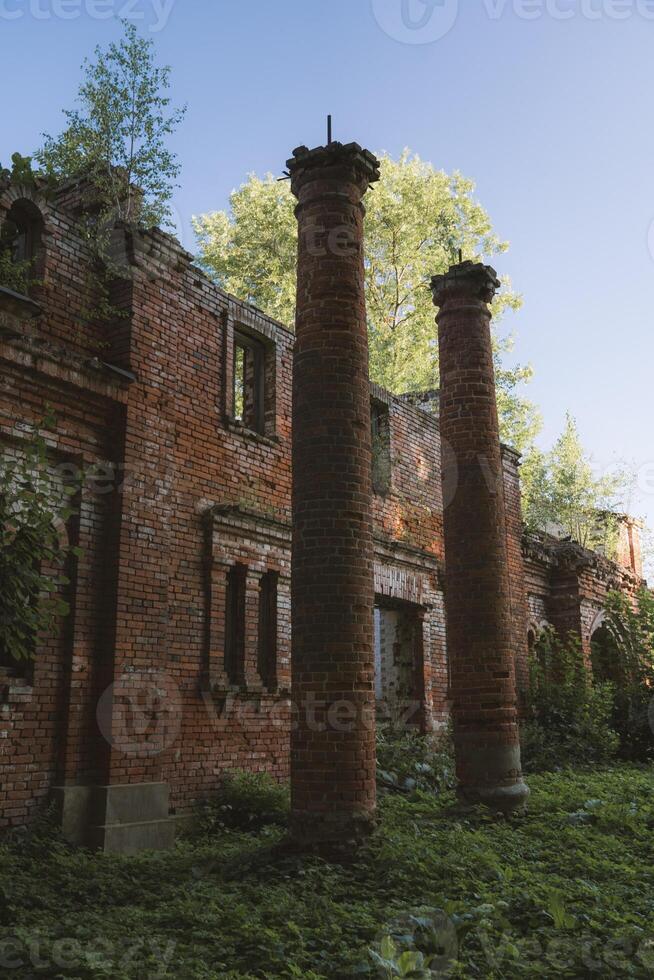 The columns of the destroyed red brick stable. 19th century buildings. photo