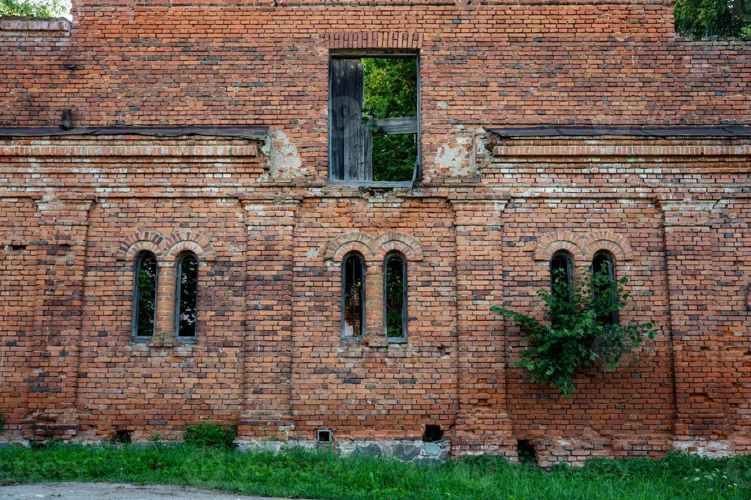 Vertical, narrow windows of a brick stable. 19th century buildings photo