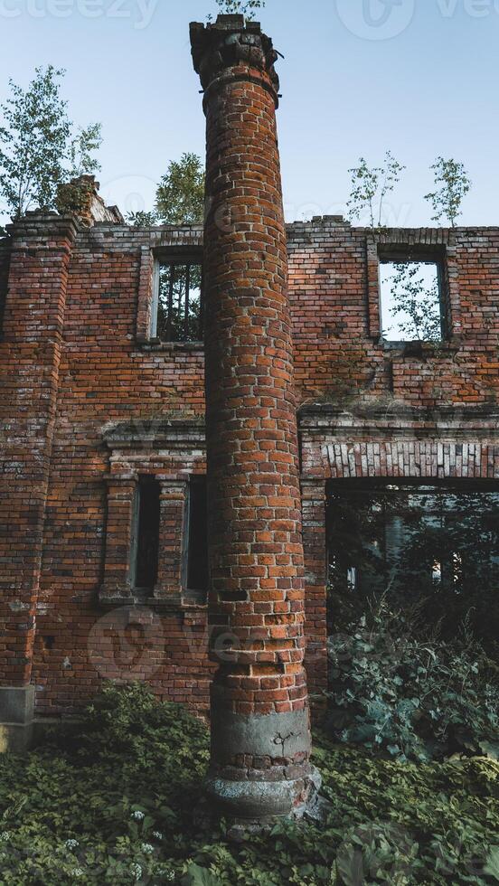 An old, dilapidated, brick column, at the entrance to the stable photo