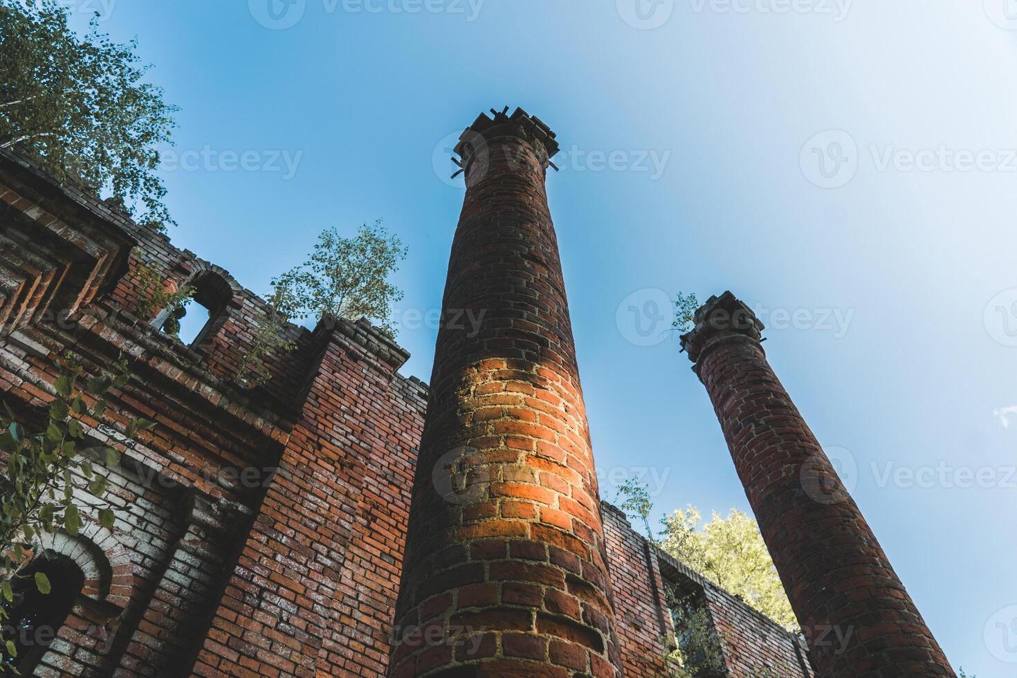 Two old, dilapidated, brick columns, bottom-up view photo