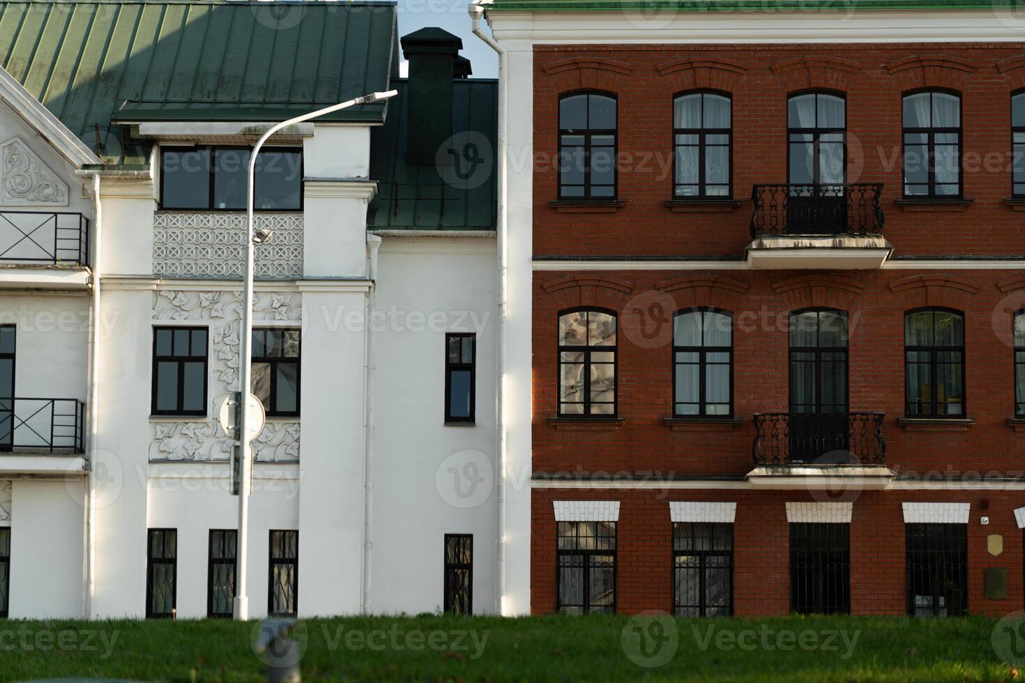 Two houses standing side by side in different styles of construction photo