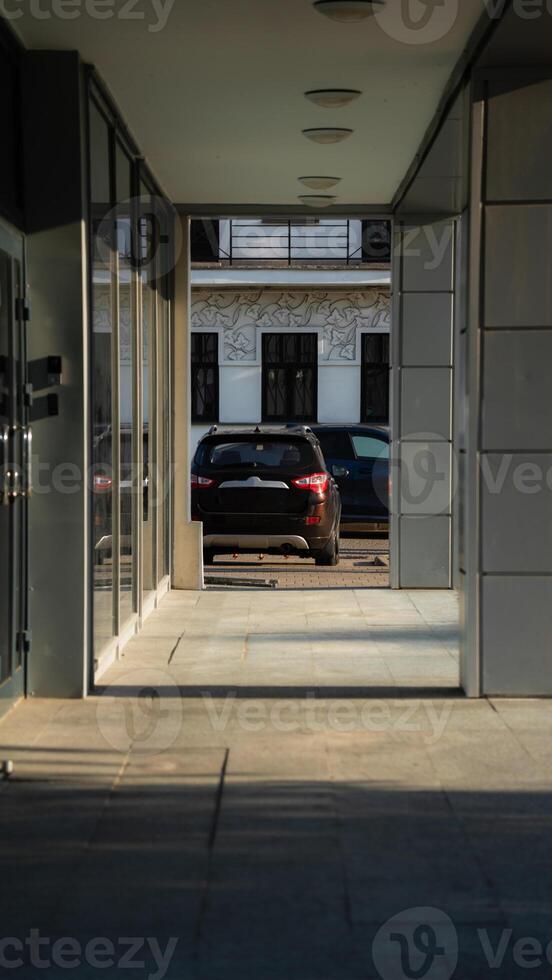 Office building, framing, diagonal, car in the distance photo