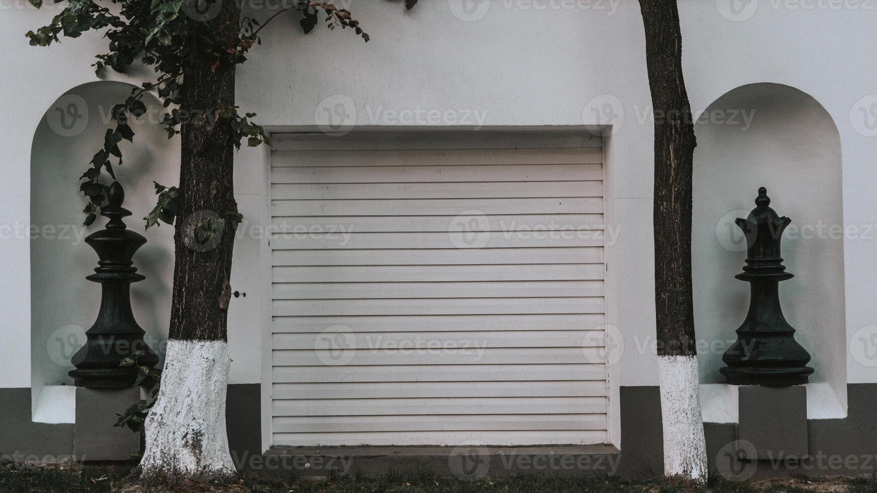 Two huge chess pieces in the wall between the gates photo