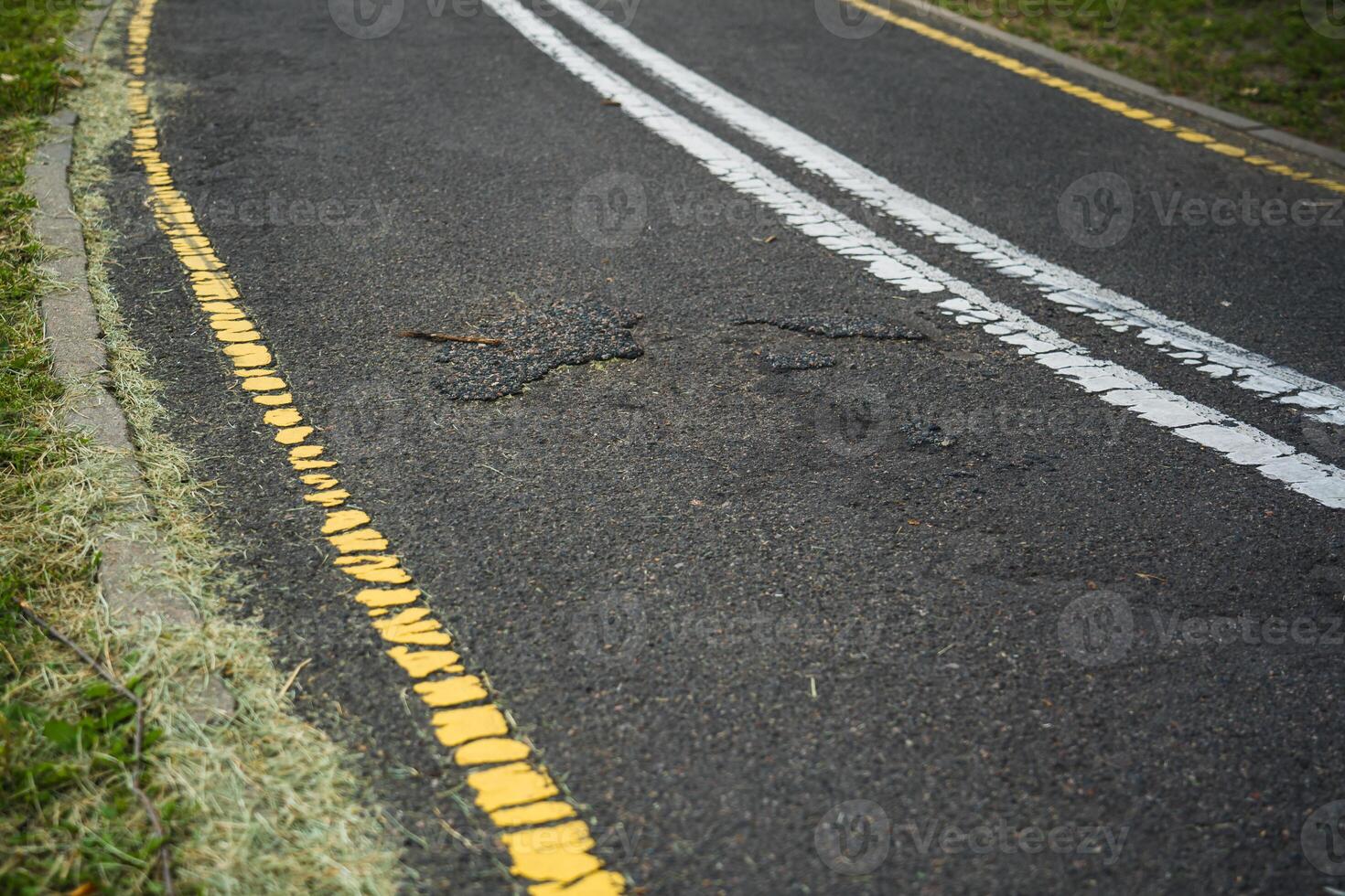 Broken asphalt on the bike path photo