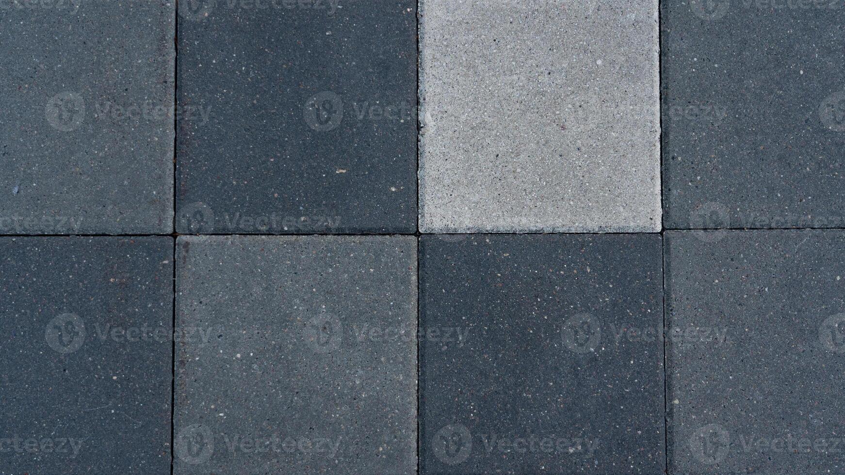 The paving slabs are square in shape. Square paving slabs of different colors photo