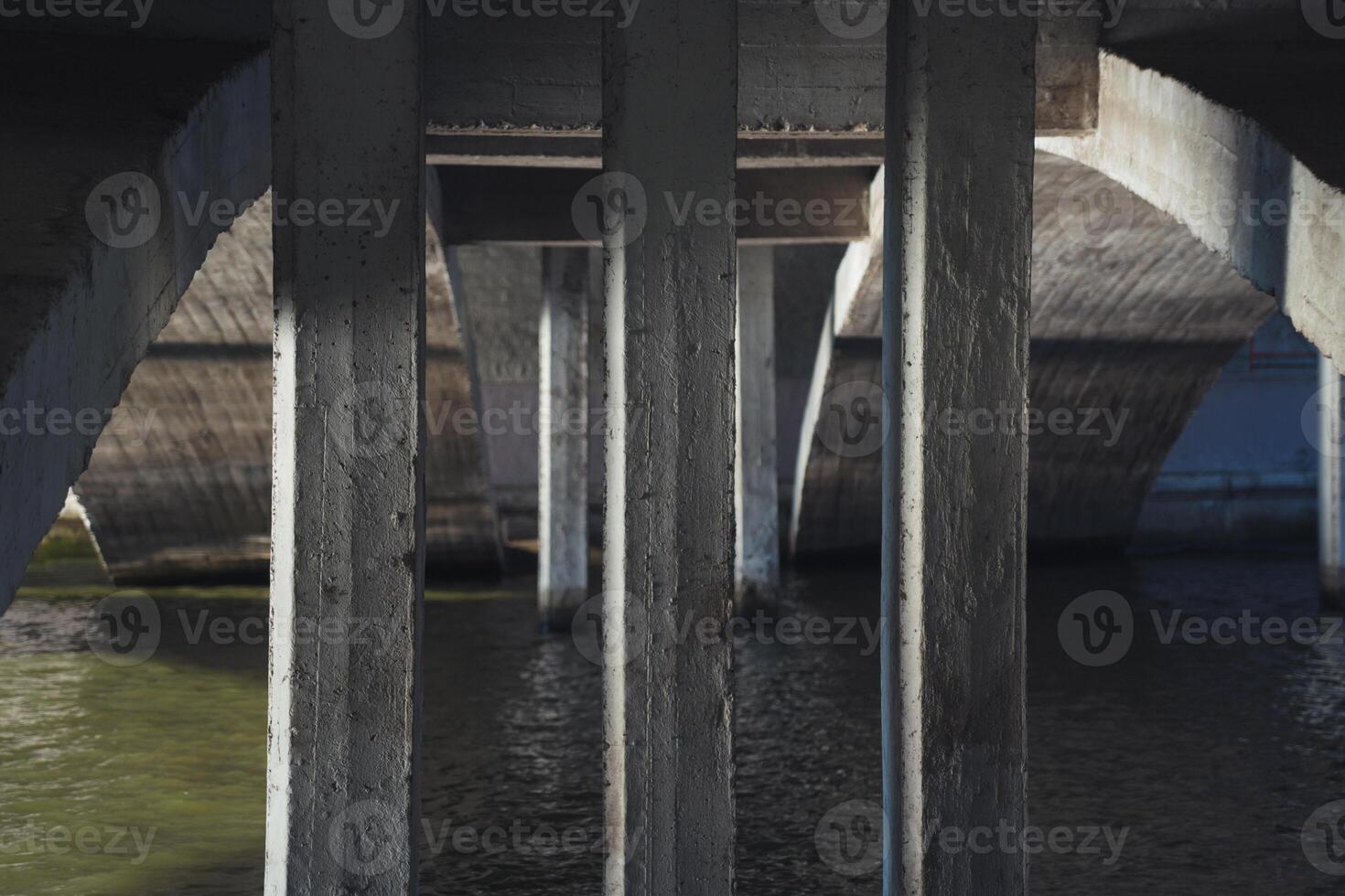 Concrete bridge supports, under the bridge over the river photo