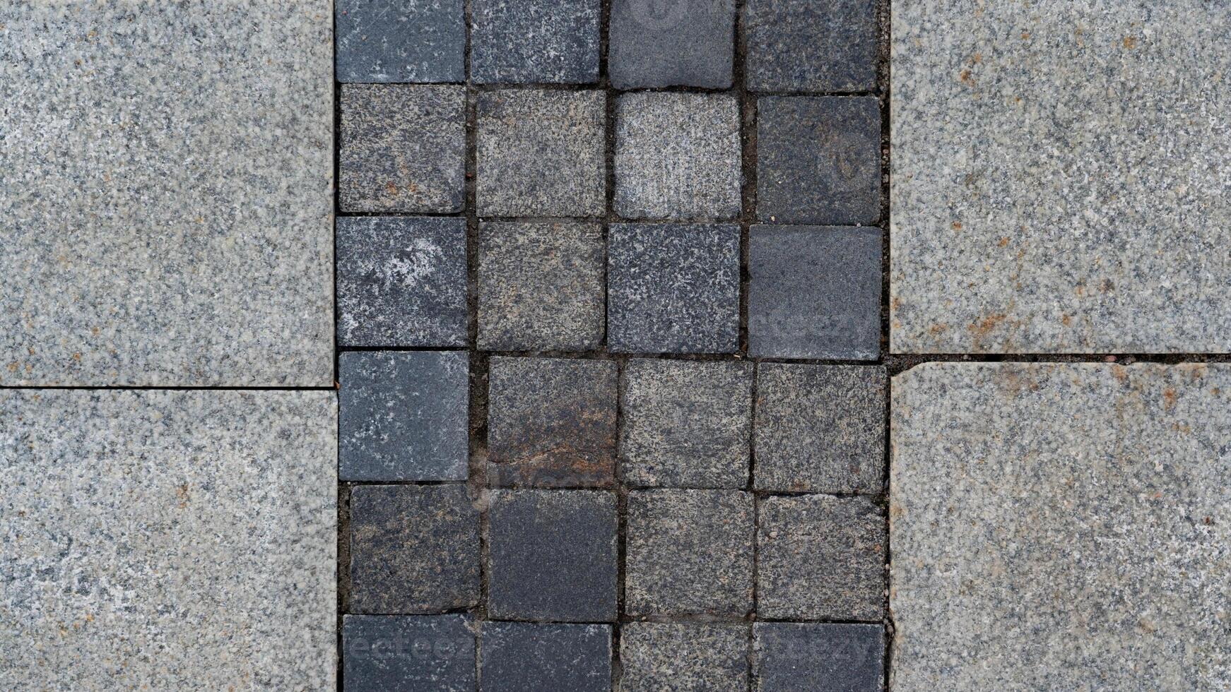 The paving slabs are square in shape. Square paving slabs photo