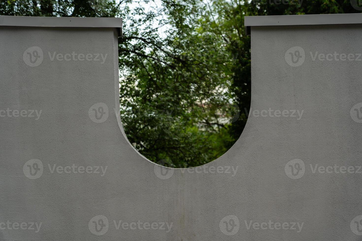 An unusual shaped wall in the park. The inverted arch photo