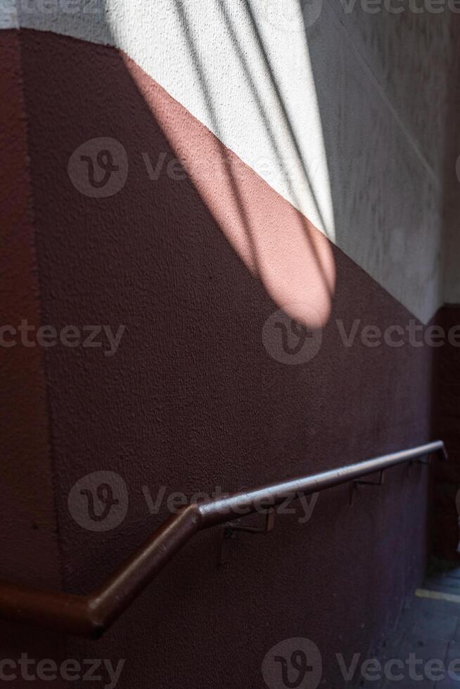 Pedestrian crossing to the railway station. Sunlight falls on the wall photo